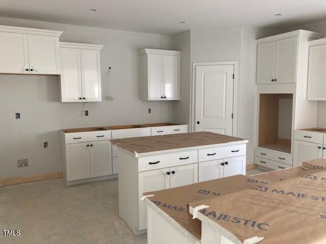 kitchen with a kitchen island and white cabinetry