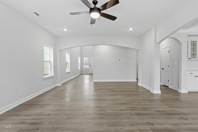 unfurnished living room featuring hardwood / wood-style floors and ceiling fan