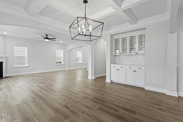 unfurnished living room featuring coffered ceiling, dark hardwood / wood-style floors, and ceiling fan