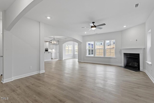 unfurnished living room featuring light hardwood / wood-style flooring and ceiling fan