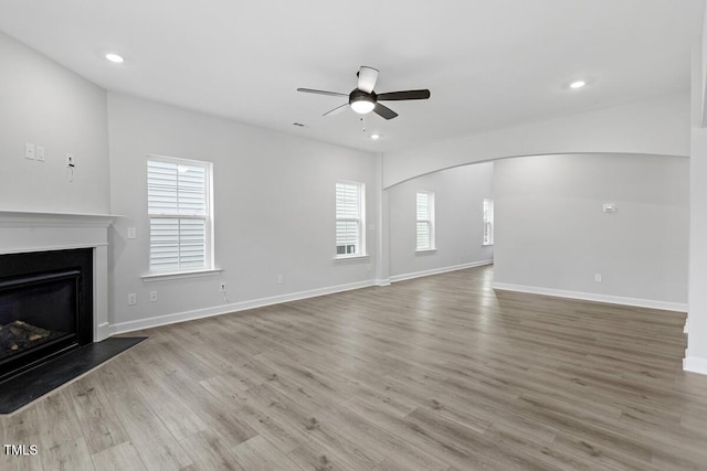 unfurnished living room featuring light wood-type flooring and ceiling fan