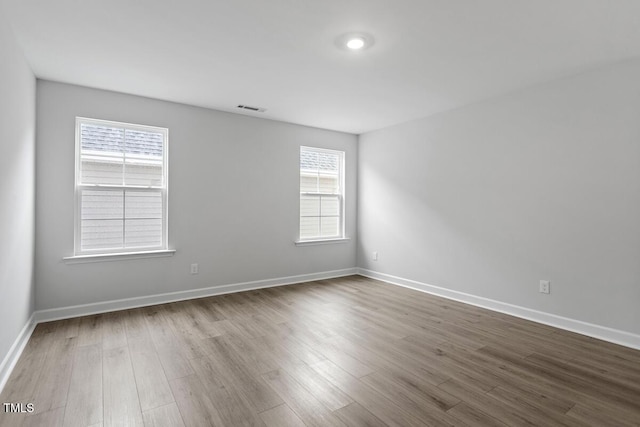 spare room with wood-type flooring