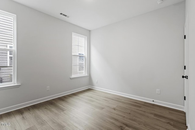 empty room with hardwood / wood-style flooring