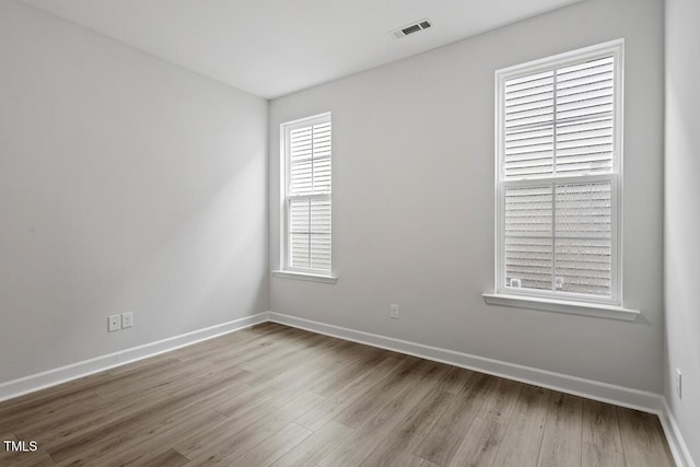 spare room featuring light wood-type flooring