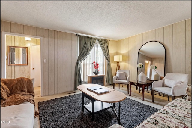 living room with a textured ceiling and wooden walls