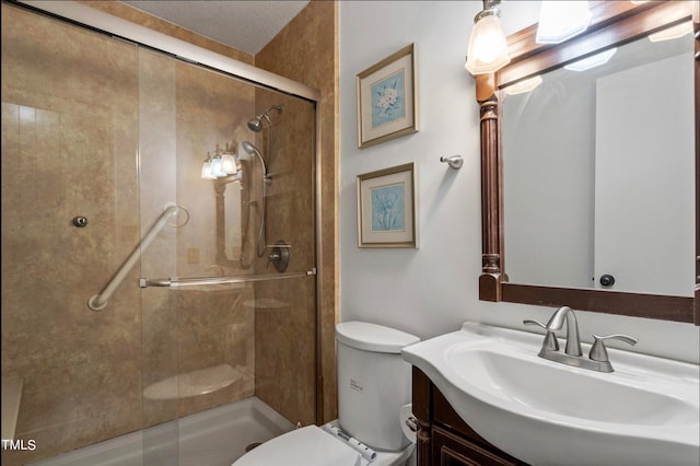 bathroom with toilet, an enclosed shower, a textured ceiling, and vanity