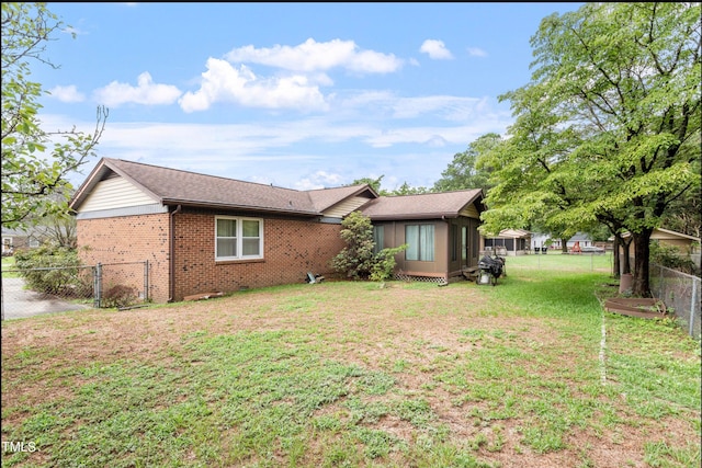 back of house with a lawn