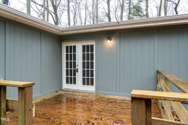 view of exterior entry with french doors and a deck