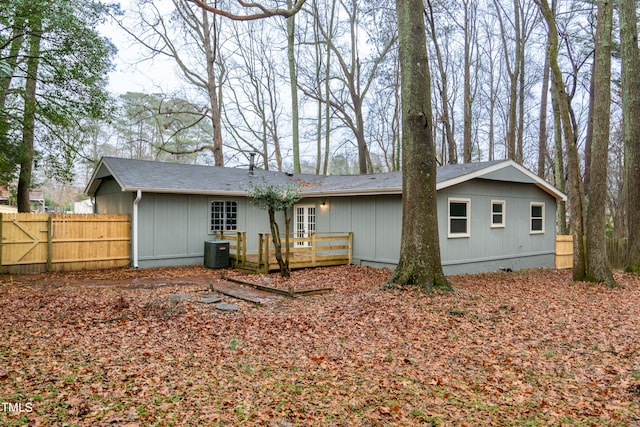 back of property featuring cooling unit and a wooden deck