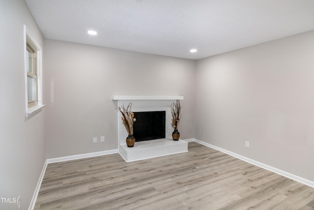 unfurnished living room with light hardwood / wood-style floors and a fireplace