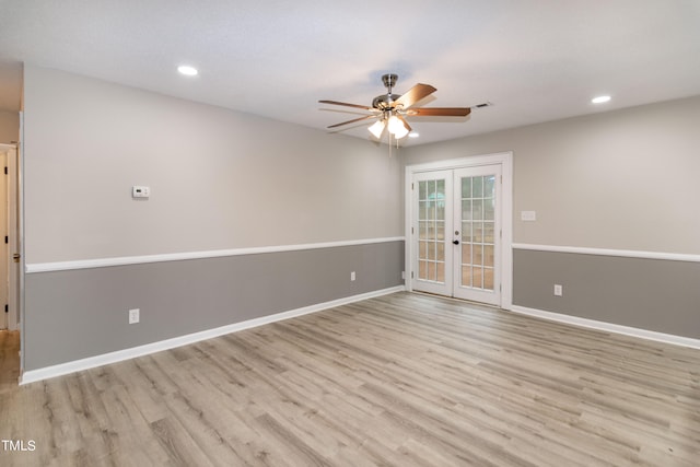 empty room with light hardwood / wood-style flooring, ceiling fan, and french doors