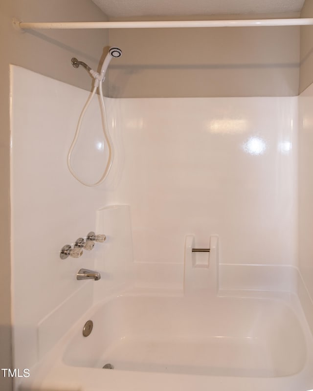 bathroom with washtub / shower combination