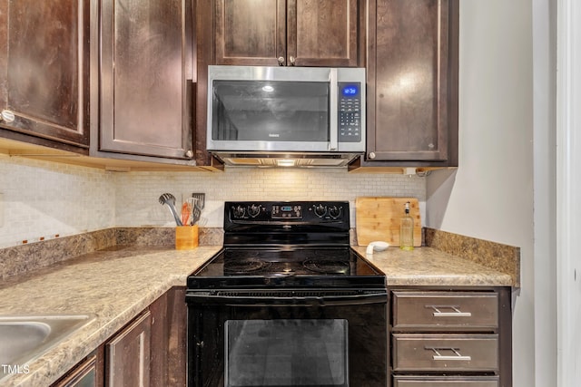 kitchen featuring black / electric stove and dark brown cabinets