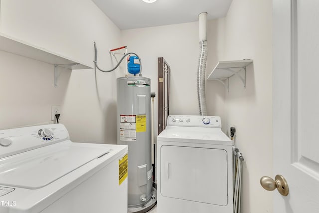 clothes washing area with washing machine and dryer and water heater