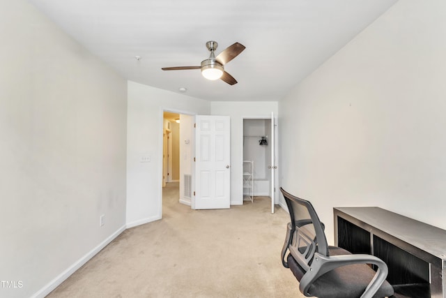 carpeted office space with ceiling fan