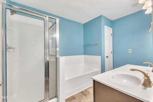 bathroom featuring tile patterned floors, vanity, and shower with separate bathtub