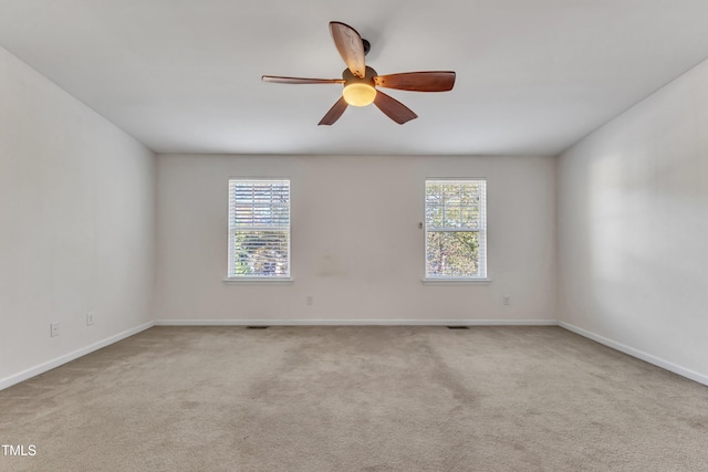 carpeted empty room featuring ceiling fan