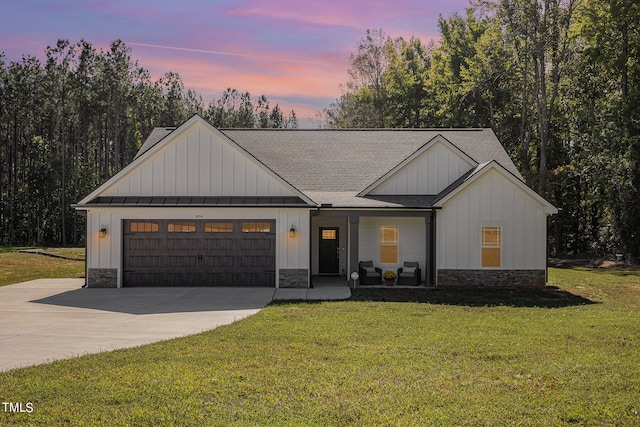 view of front of property featuring a garage and a lawn