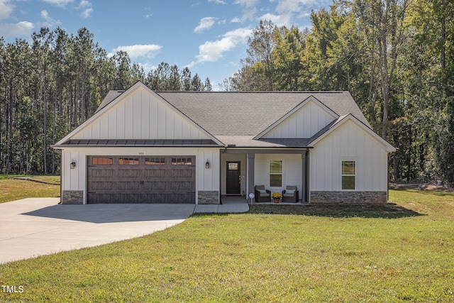 view of front of property with a front yard and a garage