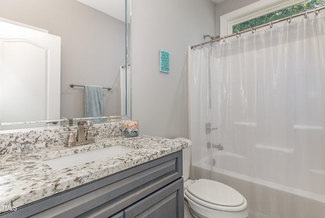 full bathroom featuring shower / bath combination with curtain, vanity, and toilet