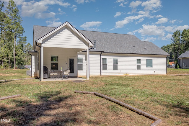 back of property with a lawn, a patio area, and central AC unit