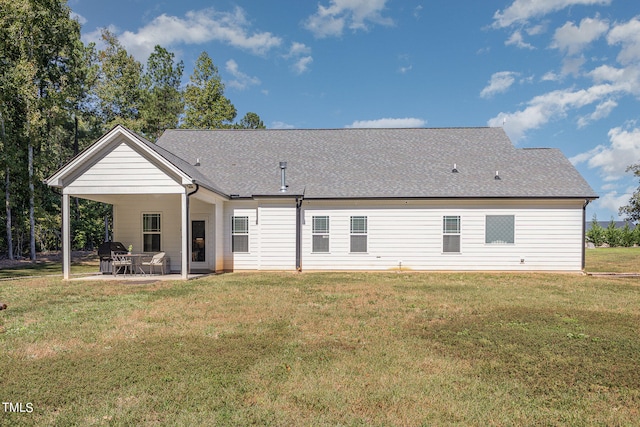 back of property with a lawn and a patio area