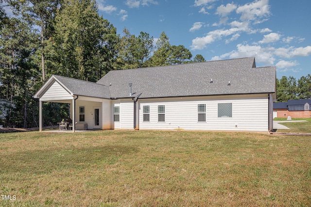 rear view of house featuring a yard and a patio area