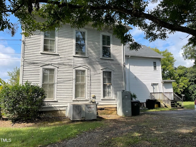 rear view of property featuring central AC