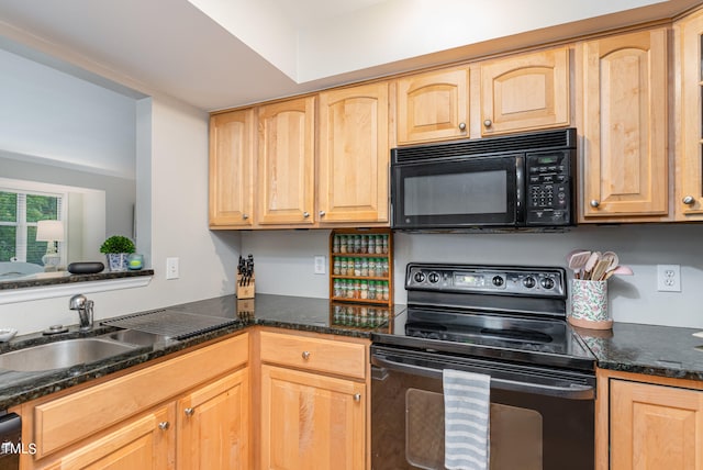 kitchen with light brown cabinetry, sink, dark stone countertops, and black appliances