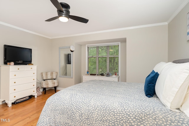 bedroom with ceiling fan, crown molding, and wood-type flooring