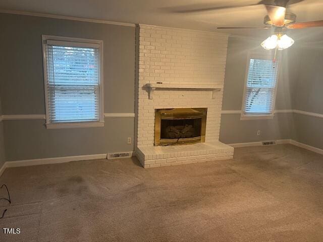 unfurnished living room with crown molding, carpet, a fireplace, and baseboards