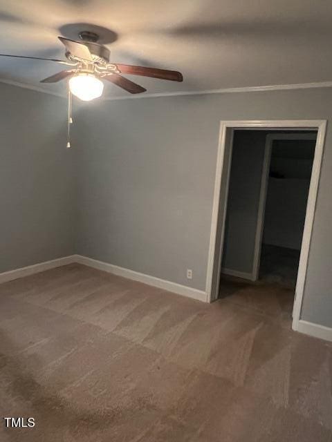 unfurnished room with crown molding and light colored carpet