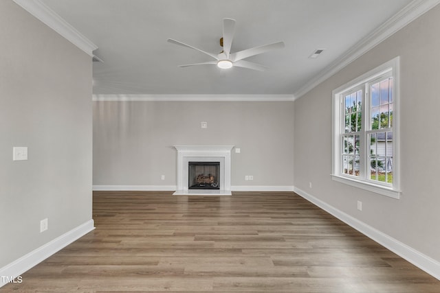 unfurnished living room with ceiling fan, ornamental molding, and light hardwood / wood-style floors