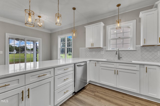 kitchen featuring light hardwood / wood-style flooring, white cabinetry, decorative light fixtures, and sink