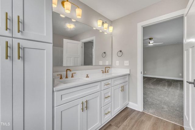 bathroom featuring hardwood / wood-style floors, ceiling fan, and vanity