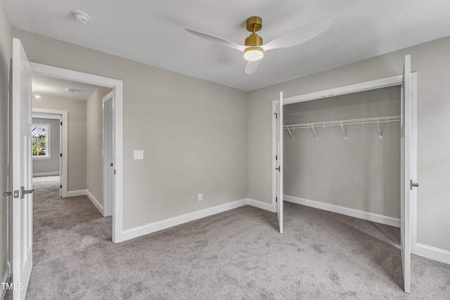 unfurnished bedroom featuring ceiling fan, light colored carpet, and a closet