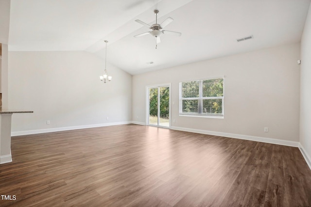 spare room featuring lofted ceiling, ceiling fan with notable chandelier, wood finished floors, visible vents, and baseboards