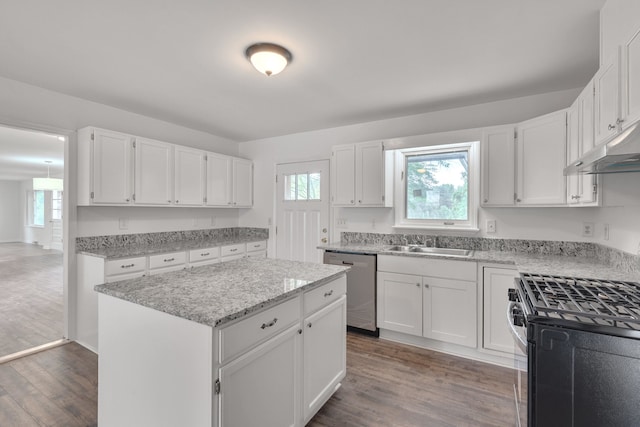 kitchen featuring dark hardwood / wood-style floors, sink, white cabinetry, a kitchen island, and appliances with stainless steel finishes