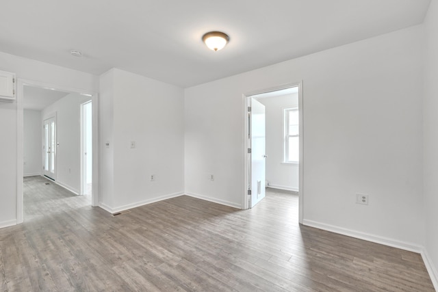 unfurnished room with dark hardwood / wood-style flooring