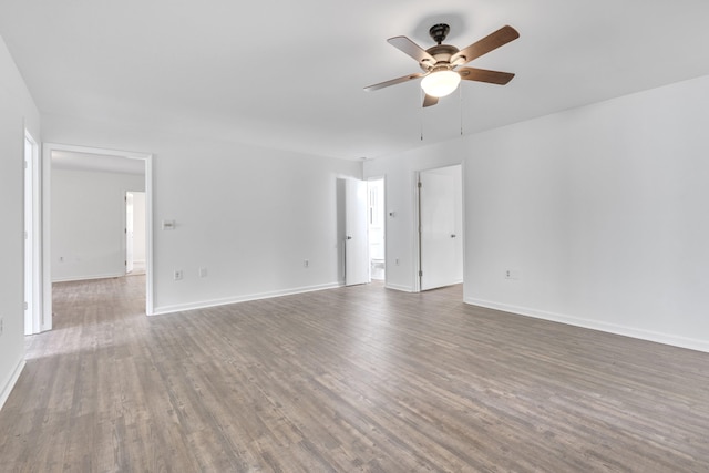 empty room with ceiling fan and dark hardwood / wood-style floors