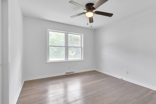 empty room with ceiling fan and hardwood / wood-style flooring