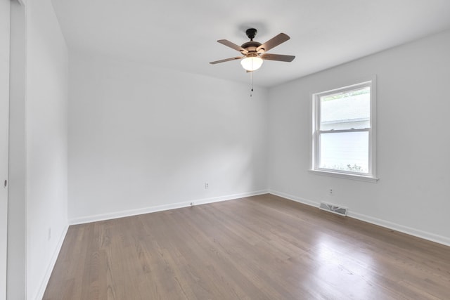 empty room featuring ceiling fan and hardwood / wood-style flooring