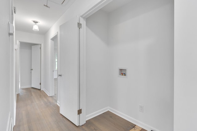 hallway with light hardwood / wood-style floors