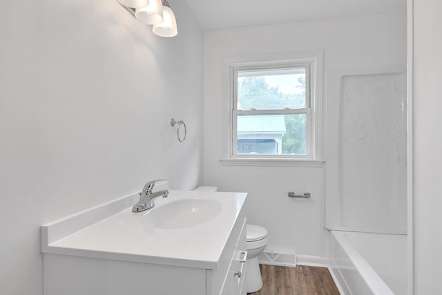 bathroom with vanity, hardwood / wood-style floors, and toilet