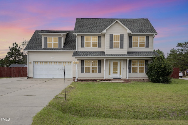 view of front of house featuring a lawn and a garage