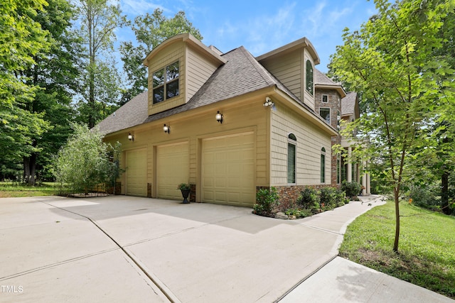 view of property exterior with a lawn and a garage