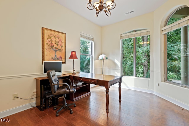 home office featuring wood-type flooring and an inviting chandelier