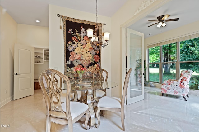 dining area with ceiling fan with notable chandelier