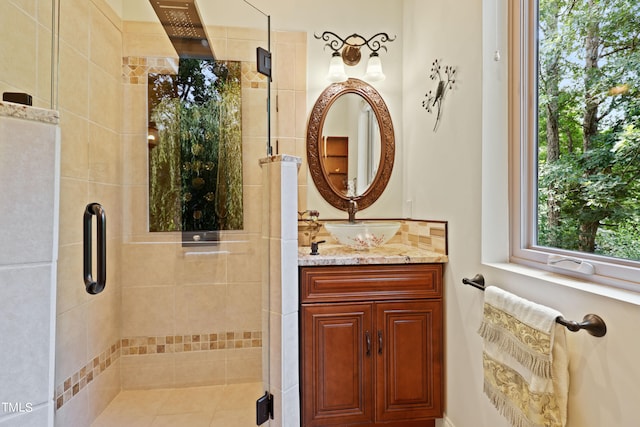 bathroom with vanity and a shower with door