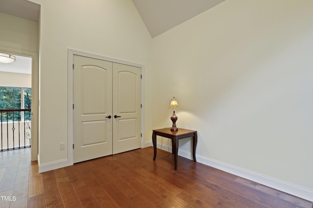 entryway featuring hardwood / wood-style floors and high vaulted ceiling